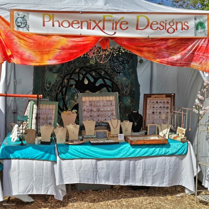 Handcrafted gemstone jewelry and wire wrapped tree of life pendants by PhoenixFire Designs craft show booth display at the Bay Area Renaissance Festival March 2015